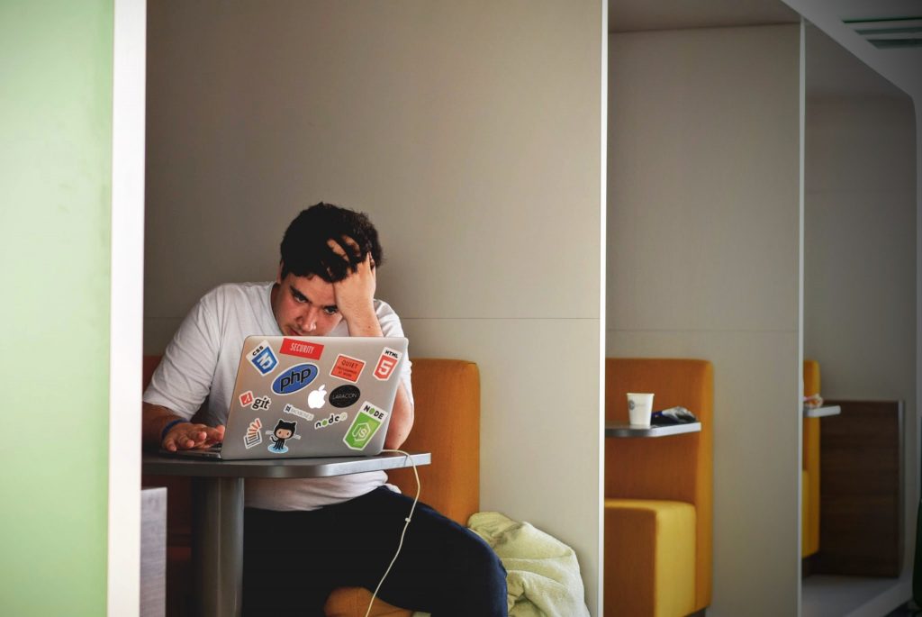 man stressed looking at laptop